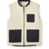 Cream sleeveless zip-front vest with black trim and multiple patch pockets, minimalist utility gilet on white background