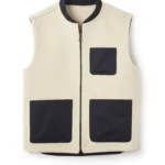 Cream sleeveless zip-front vest with black trim and multiple patch pockets, minimalist utility gilet on white background