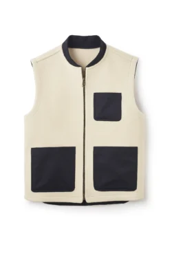 Cream sleeveless zip-front vest with black trim and multiple patch pockets, minimalist utility gilet on white background